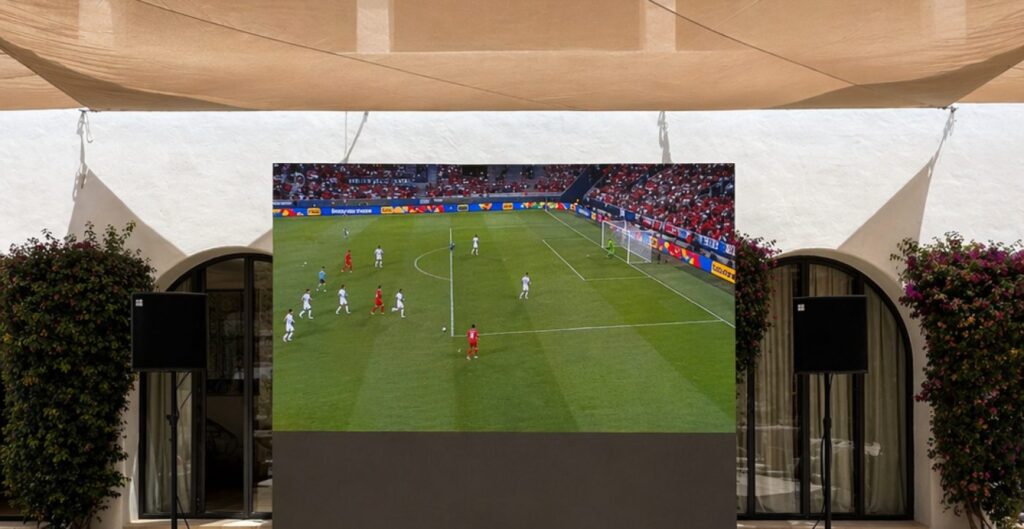 Big LED screen showing live football on an Ibiza terrace